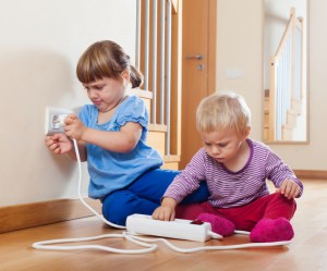 Two children  playing with electrical extension
