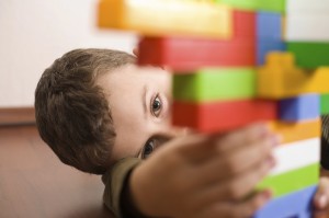 Cute kid playing with cubes